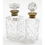 A pair of cut glass decanters, each with silver collar, one square set, Birmingham 1974, 25cm high,