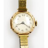 A 9ct gold ladies wristwatch, with silvered coloured dial and blue hands, on an expanding gold plate