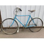 A blue gentleman's bicycle.