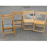 Four wooden folding chairs, two with slatted seats and two with leather inset seats.