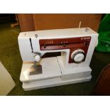 A Singer 6103 white sewing machine and case, with foot pedal.