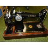 An early 20thC Singer cased sewing machine.