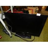 A Linsar 20" flat screen television with remote control.