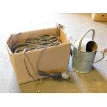 A group of various rope, inspection lamp and a galvanized watering can.