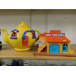 A small group of toys, to include a yellow kettle house, and a Blacksmiths and Sheriff's office play