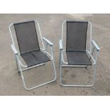 Two folding garden chairs.