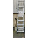 Two aluminium step ladders, and three shovels.