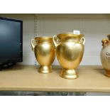 Two Sia collection gold painted porcelain urns, 26cm high.