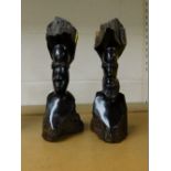 Two African wooden tribal art figures, each of a carved male bust, 26cm high.