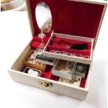 A cream leatherette jewellery box and contents, to include various decorative brooches, shell neckla