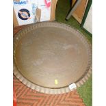 A large Eastern brass serving tray, with hammered decoration, 60cm wide.