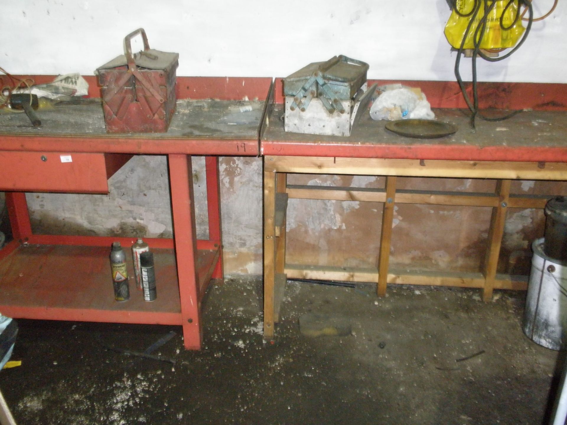 Four red steel work benches, one with a wooden base.