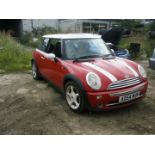 A Mini Cooper, registration AD54 MHM, 105,665 miles. Vehicle has been started and run around the ya