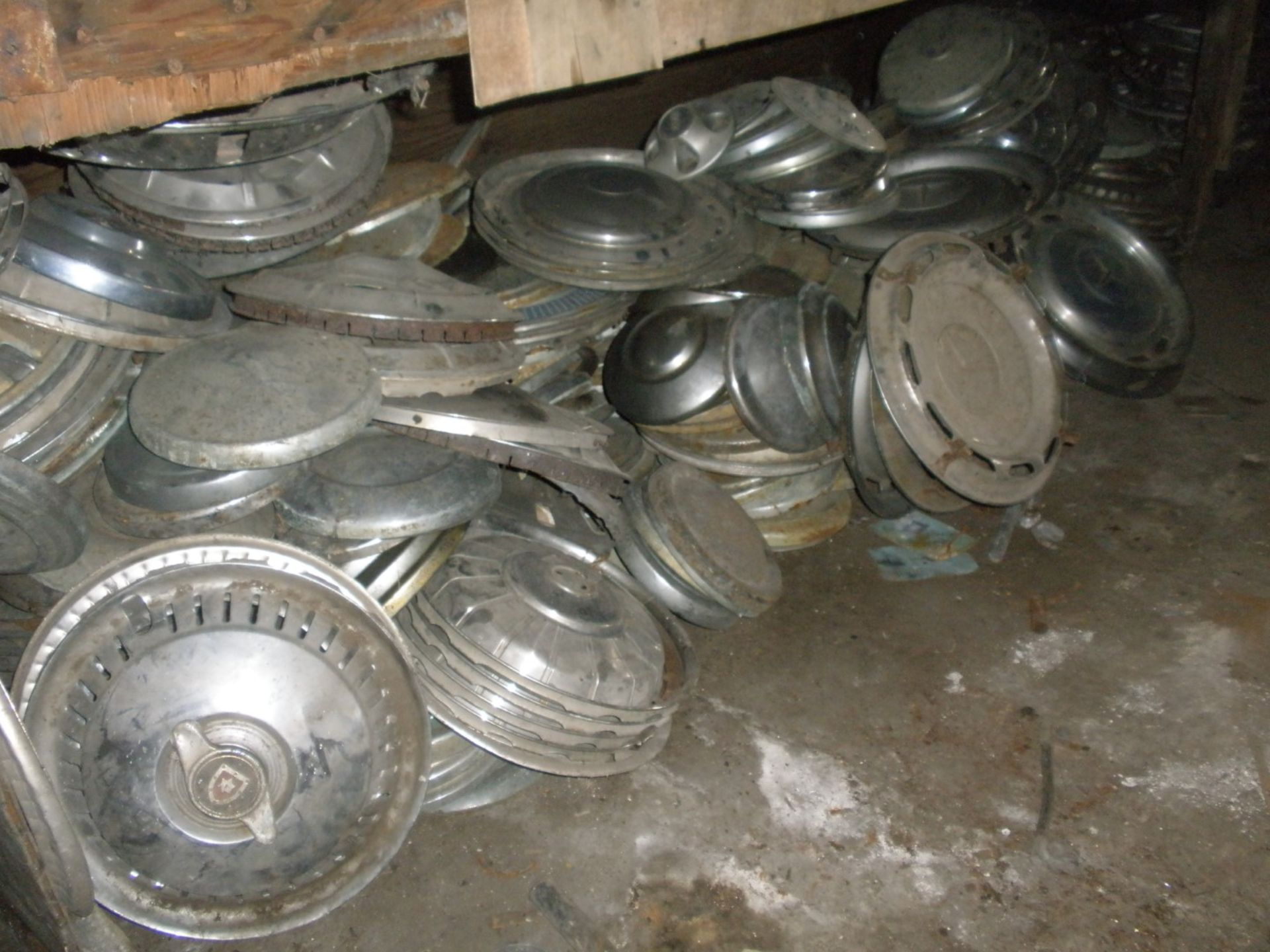 A large quantity of metal hub caps and wheel trims for classic cars, to includ Mercedes, Trimuph, Wo
