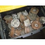 A large plastic container full of speedometers and dials for vintage and collectors cars.