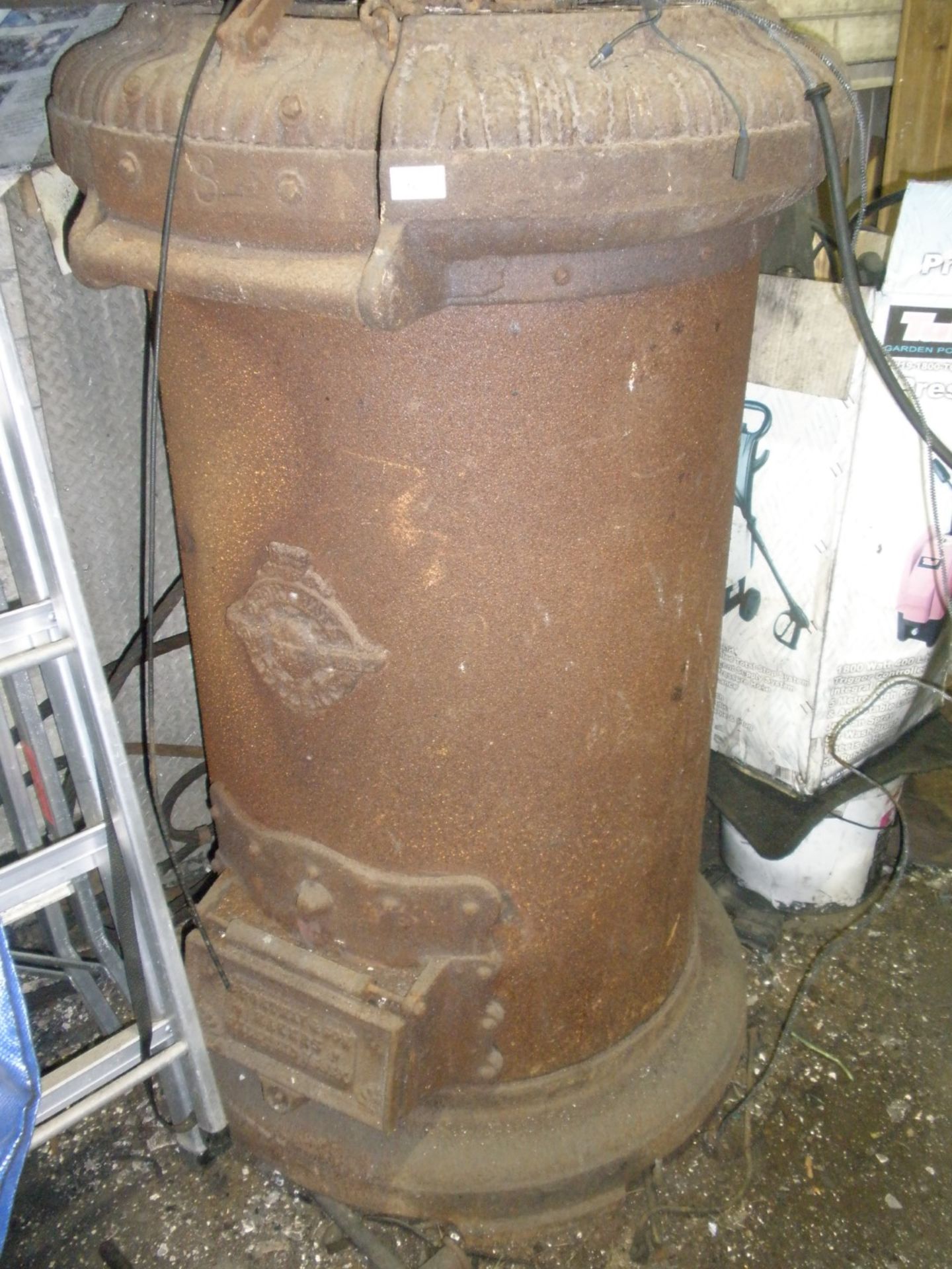 A large cast iron Fortnay & Sons cylindrical stove.