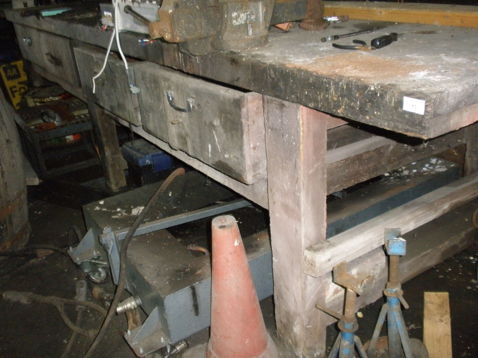 A large wooden work bench for four drawers.