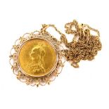 A Victorian full gold sovereign pendant, dated 1892, in a 9ct gold fretwork frame, on fine link chai