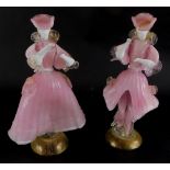A pair of Murano Italian glass figurines, depicting a lady and gentleman each wearing pink costume,