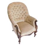 A Victorian walnut armchair, with beige buttoned back, with scroll carved supports on shaped legs wi