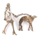 A silver and marcasite brooch, in two parts of a lady walking a dog, stamped 925, 6cm high, 14.6g al