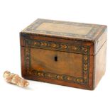 A walnut and parquetry tea caddy, the hinged lid enclosing two lidded divisions, 18cm wide, and an E