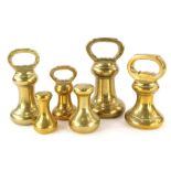 A graduated set of six brass bell weights, to include 7lb, two 4lb, 2lb, 2ln dumb weight and a 1lb d