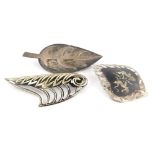 Three silver brooches, to include a Siam sterling decorative etched brooch, a silver leaf brooch mar