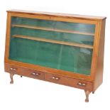 A mahogany display case, with a glazed door above two drawers, on short cabriole legs, 94cm high, 12