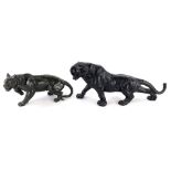 An oriental style black spelter figure of a tiger, 34cm long, and another similar, 23cm long. (2)