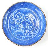 A Japanese blue and white saucer dish, with brown glaze border, 25cm diameter.