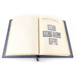 A 1935 Silver Jubilee stamp album, containing Commonwealth mint stamps, etc.