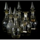 A set of six cut glass decanters, in two sizes, each with a tapering stopper, single ring neck and d