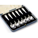 A set of six George V silver teaspoons, with shell cast handles, Sheffield 1911, 1¾oz, boxed.