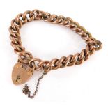 A 9ct gold charm bracelet, with heavy curb links, on a heart shaped padlock with safety chain, stamp