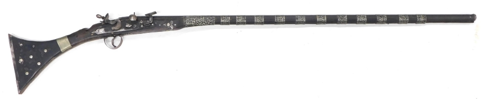 A Middle Eastern replica rifle, with silver coloured metal bands, etc., 141cm long.