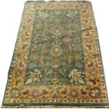 A Persian rug, with a design of flowers, leaves etc, medallions etc, on a green ground with one wide