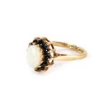 A 9ct gold dress ring, the central cluster with oval opal surrounded by dark blue round brilliant cu