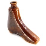 A 19thC treacle glazed flask, modelled in the form of a boot, 16cm high.