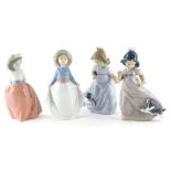 Four Nao porcelain figures, each depicting young children in various poses, one with a puppy, 17cm h
