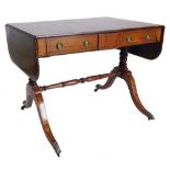 A 19thC satinwood and mahogany sofa table, with ebony stringing, the rectangular top with rounded en