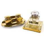 An oval brass inkstand, with two wells, 17cm wide and a square brass inkstand with cut glass well, 1