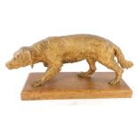 A gilt spelter figure of a hound, on an oak base, 38cm wide.