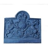 A cast iron fire back, decorated with a crest, 65cm high, 73cm wide.