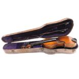 A late 19thC/early 20thC violin, with a two piece back, length of back 36cm, sold with a bow and a h