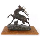 A bronzed spelter figure of a stag, indistinctly signed, 27cm wide, on associated oak plinth.