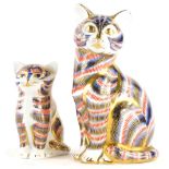 Two Royal Crown Derby porcelain paperweights of cats, with silver coloured stoppers, the largest 12c