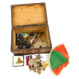 A quantity of military related items, to include World War Two medal, badges, a cap, a small orange