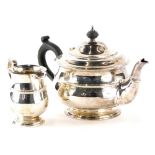 An Edward VII silver two piece tea service, comprising teapot, and milk jug, the teapot with ebonise