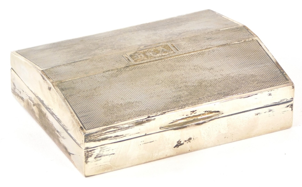 An early 20thC silver cigarette box, with engine turned decoration, and cartouche initialled D.G.A,